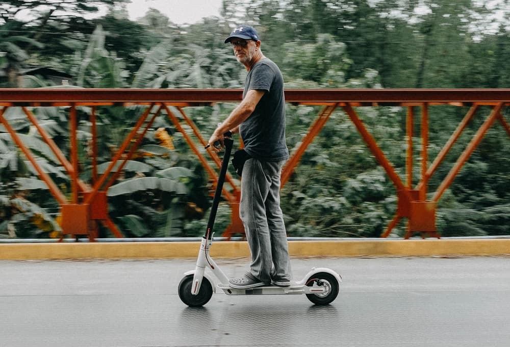 middle age man riding an electric scooter