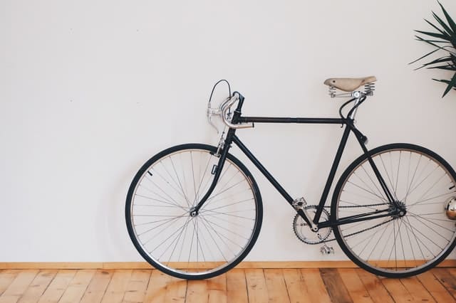 Bicycle on a white wall background