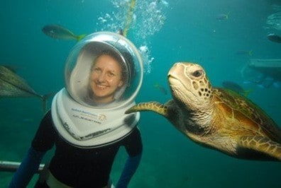 lady underwater with sea turtle