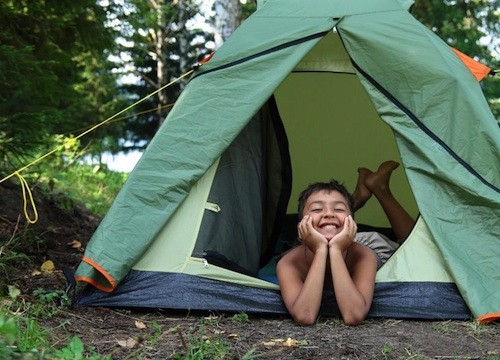 Kid inside his camping tent