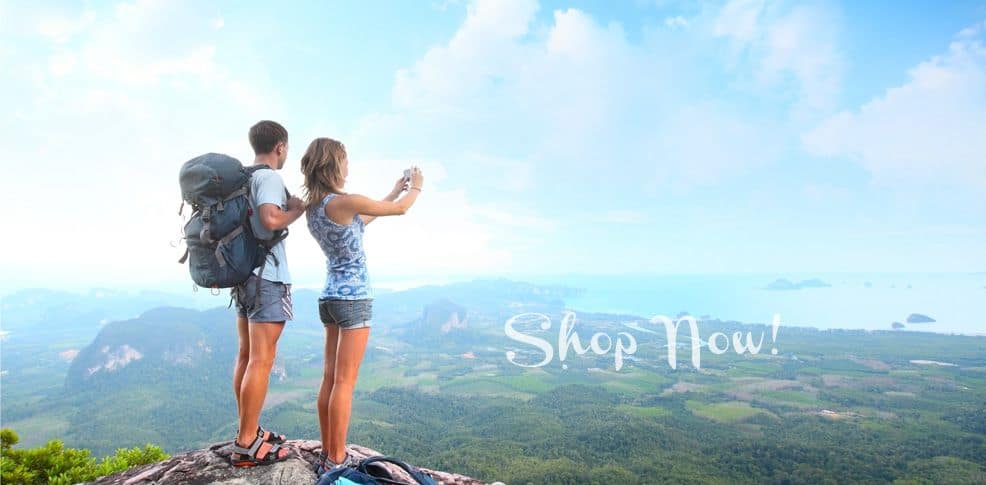 man and woman on top of the hill taking picture
