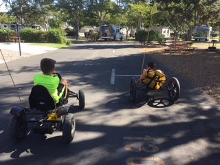 boys riding go kart in the park