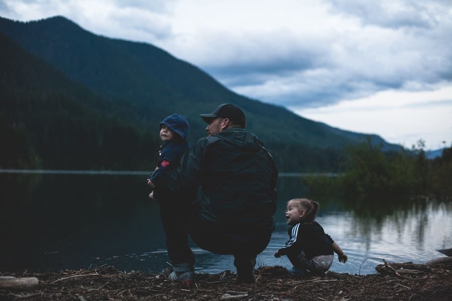 dad and 2 kids on the lake